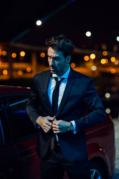 portrait of a man in suit late night well dressed man late night in the city after work sex symbol stock pictures, royalty-free photos & images