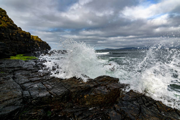 istock Waves crashing in to the cliffs 1129015413