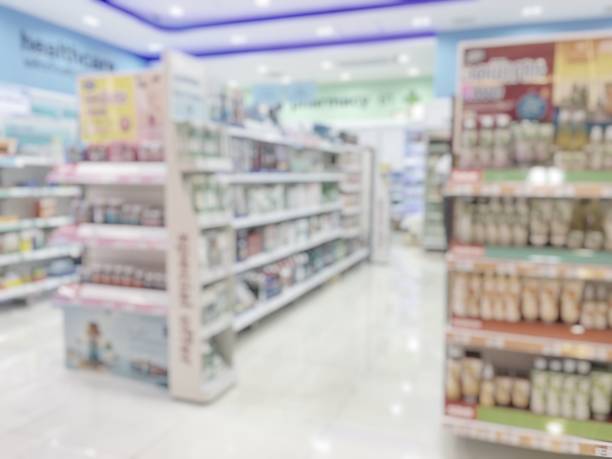 Pharmacy store or drugstore blur background with drug shelf and blurry pharmaceutical products, cosmetic and medication supplies on shelves inside retail shop interior Pharmacy store or drugstore blur background with drug shelf and blurry pharmaceutical products, cosmetic and medication supplies on shelves inside retail shop interior over the counter meds stock pictures, royalty-free photos & images