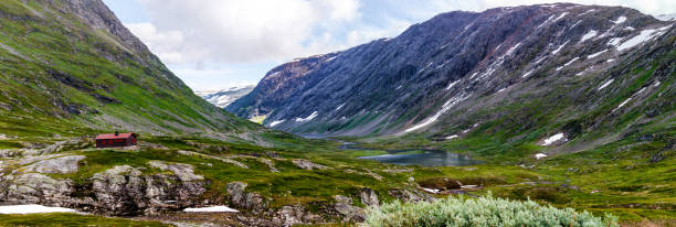 istock Panoramic view on the mountains and the lonely house among it. 1129019812