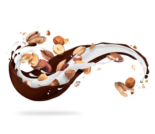 istock Different nuts with milk and chocolate splashes, isolated on white background 1129021762