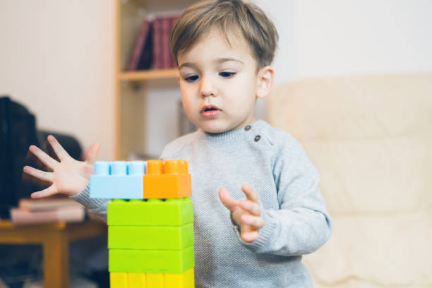 istock Little Boy Playing With Brick Block Toys at Home 1129023815