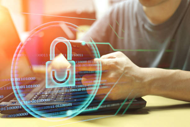 istock man using smartphone at working desk double exposure with blue light padlock icon. business security and data protection concepts. 1129023933