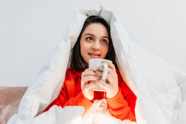 istock Young woman having coffee under the duvet 1129024547