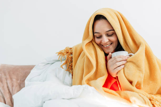 istock Young woman having coffee under the duvet 1129024555