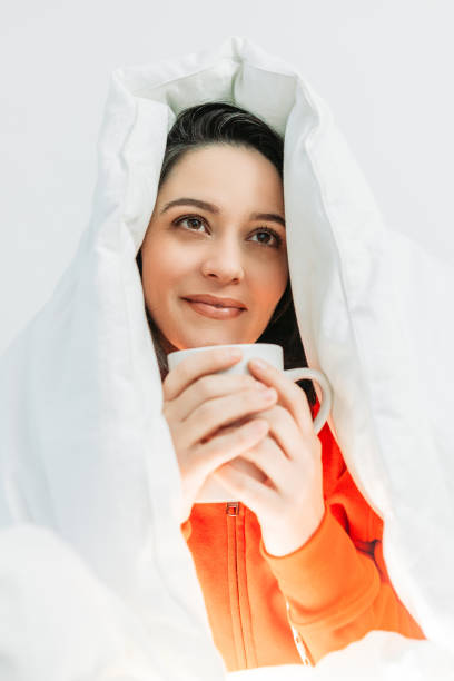 istock Young woman having coffee under the duvet 1129024576