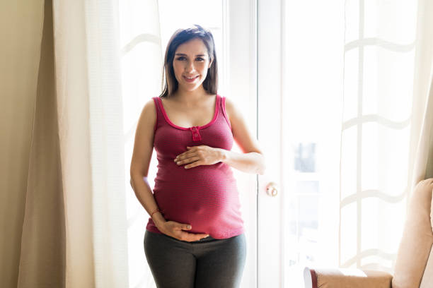 istock Expectant Woman Showing Affection Towards Fetus 1129026015
