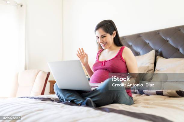 Sharing Pregnancy News Through Video Call Stock Photo - Download Image Now - Pregnant, Using Phone, One Woman Only