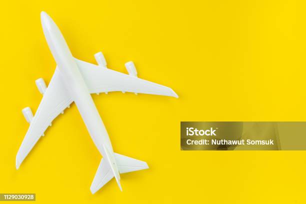 White Toy Commercial Airplane On Solid Yellow Background Using As Travel  And Transportation Business Wallpaper Stock Photo - Download Image Now -  iStock