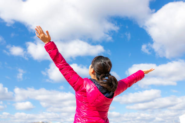 istock Woman with blue sky 1129037081