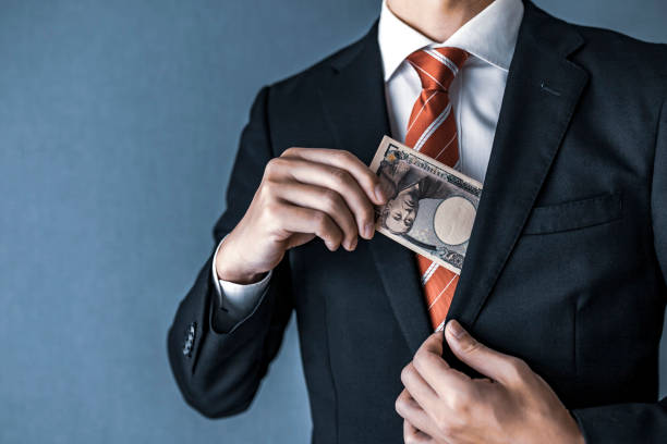 istock businessman holding Japanese yen bill 1129044460