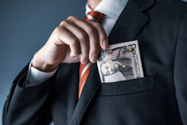 istock businessman holding Japanese yen bill 1129044464