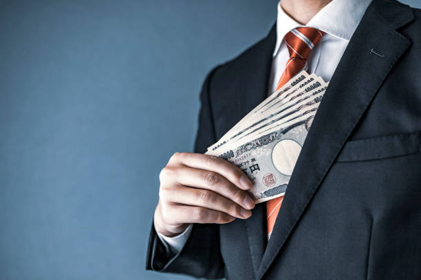istock businessman holding Japanese yen bill 1129044468