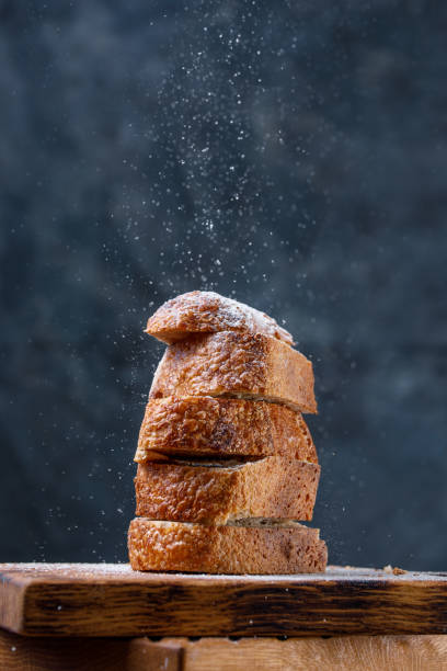 istock Fresh craft bread sliced on decorative boards with flour sprinkled on top.The concept of healthy food and traditional bakery. 1129048221
