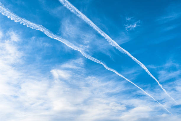 istock Jet Aircraft Contrails, Clouds, and Blue Sky 1129051023