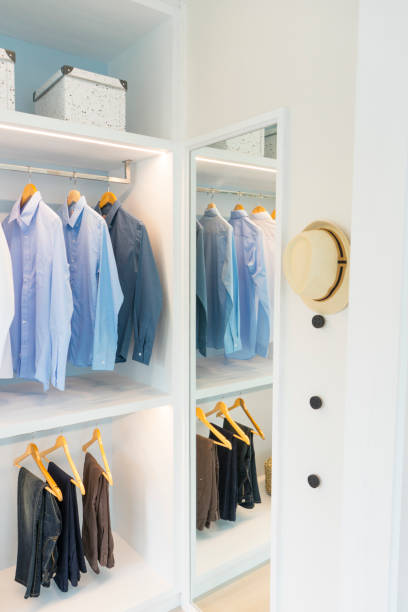 istock Stylish clothes and accessories in large wardrobe closet 1129052260