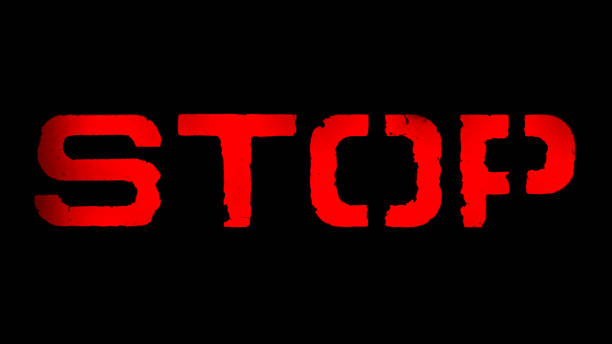 istock warning word stop in red letters on a black background 1129052274