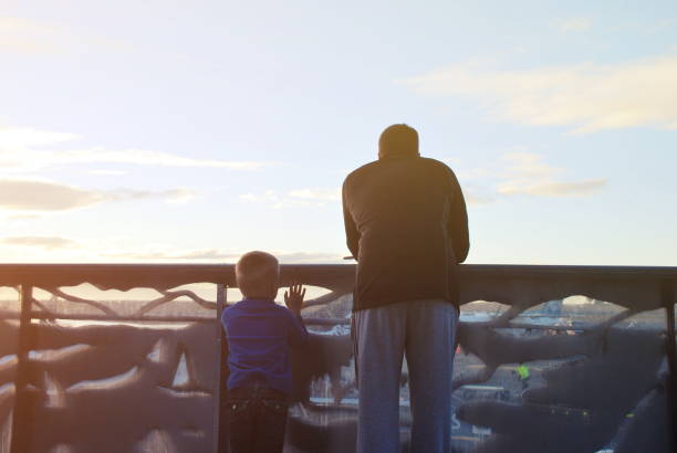 istock Father and Son waiting on Airport Runway at Sunset 1129053136