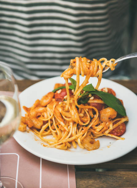 istock Man eating italian spaghetti pasta with fork 1129058104