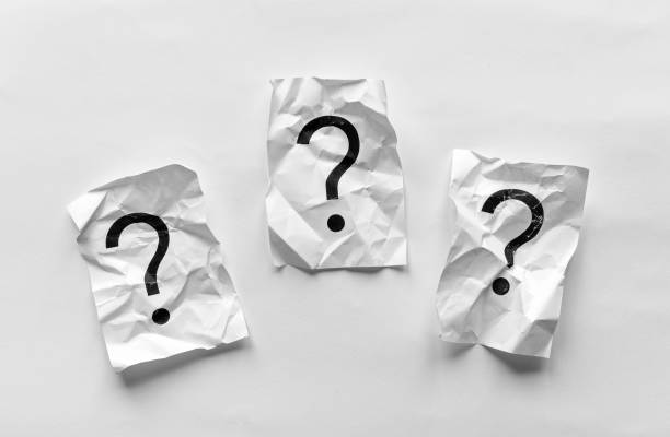 istock Crumpled pages of paper with question marks 1129062720