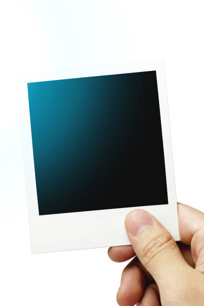 istock Hand Holding a Blank Instant Film Photo 1129062866