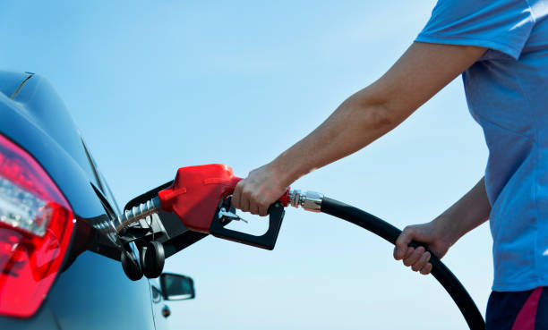 istock Man hand holding fuel pump and refilling car 1129063511