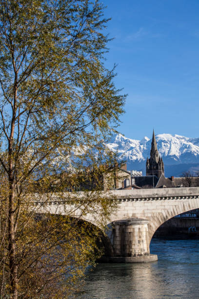 Grenoble and Isere river Grenoble city and the Belledonne massif in the  the French Alps background isere river stock pictures, royalty-free photos & images