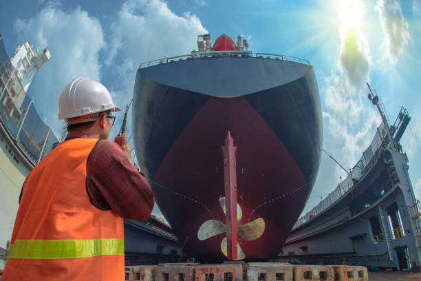 Final Inspect supervisor, foreman, inspector, surveyor takes final inspection of the cleaning, repairing, recondition of over hull of the commercial ship in dry dock yard, ready to delivery the ship to the sea dry dock stock pictures, royalty-free photos & images