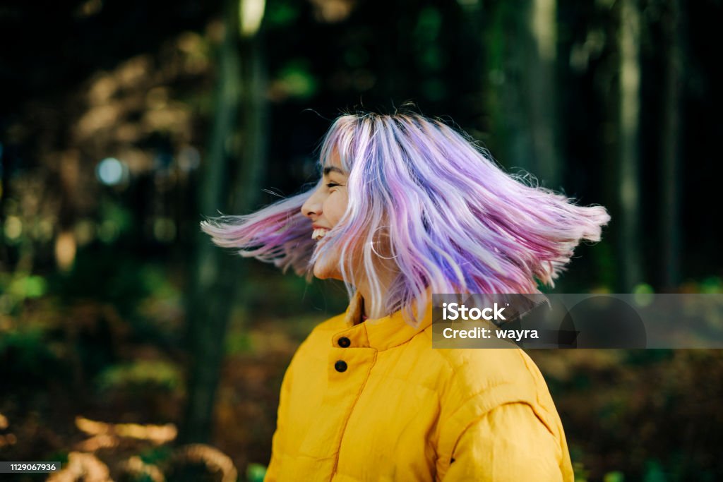 Portrait of confident, young teenage girl in Nature Portrait of confident, young, modern teenage girl with pink, blue hair in nature forest, Germany Multi Colored Stock Photo