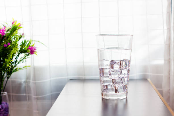 istock Glass of iced water on the table background 1129068308