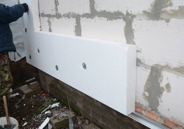 istock Building contractor insulating House Wall with styrofoam insulation sheets. 1129068348