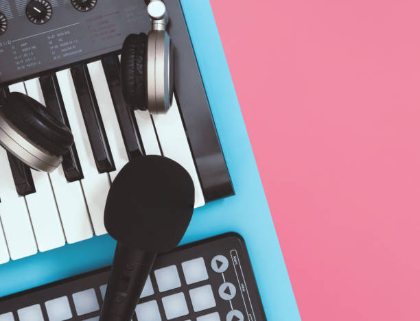 istock black microphone and headphones on table top view blue and pink background for copy space 1129068555