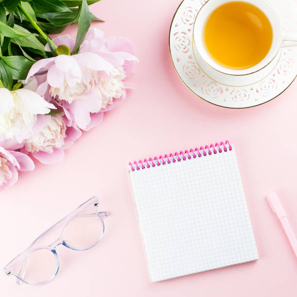 istock Beautiful cosmetics and flowers flat lay with note book, herbal tea on pastel background. 1129069161