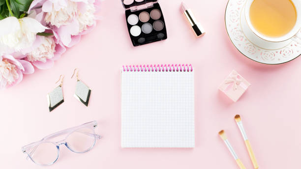 istock Beautiful cosmetics and flowers flat lay with note book, herbal tea on pastel background. 1129069174
