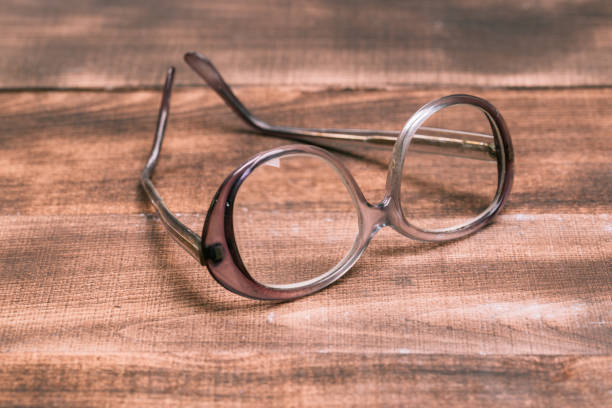 istock A pair of glasses on a wooden table 1129069421