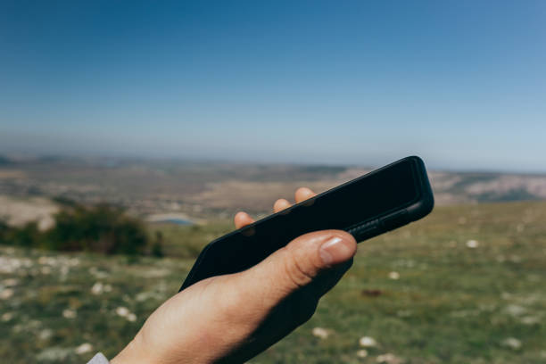 istock Close up of a man using mobile smart phone outdoor 1129069430