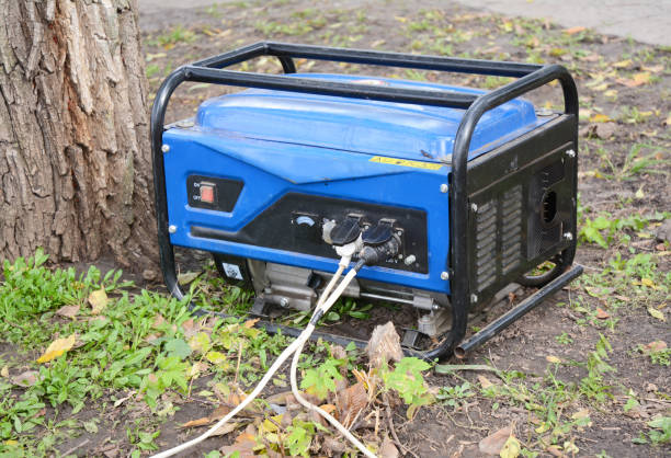 standby generator - outdoor power equipment. portable generator on the house construction site. close up on home mobile backup generator. - gerador imagens e fotografias de stock