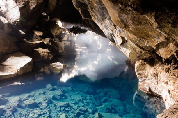 istock Crystal clear lake in rocky cave 1129071067
