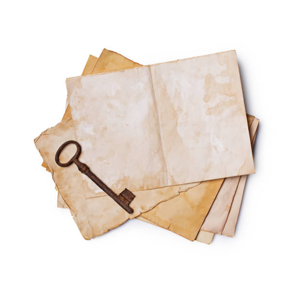 istock Mockup of empty old vintage yellowed paper sheet and rusty key 1129071304