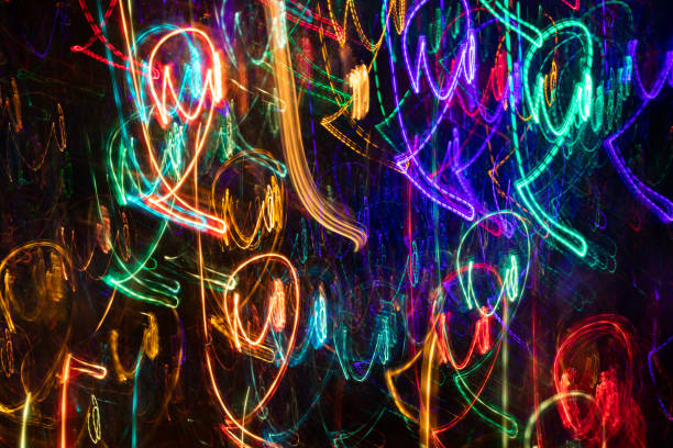 istock Abstract pattern of multicolored light chaotic strokes on black background. 1129074274