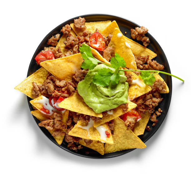 plate of corn chips nachos with fried minced meat plate of corn chips nachos with fried minced meat and guacamole isolated on white background, top view nacho chip photos stock pictures, royalty-free photos & images
