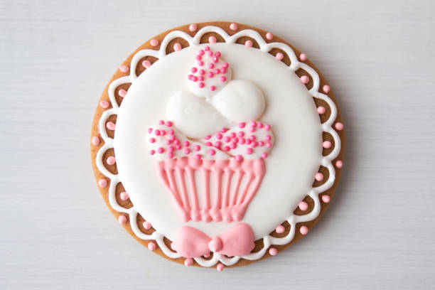 Gingerbread with cupcake on white table.