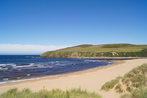 Melvich beach with blue sky and sunshine. the beach is in the north of Scotland in Sutherland. Part of North coast 500.