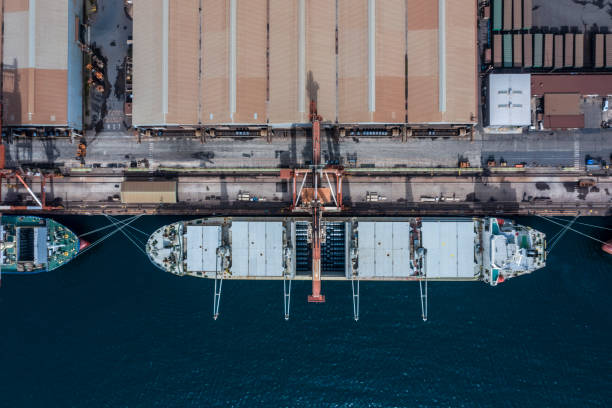 istock A container ship was anchored at a port with a logistics warehouse. 1129078698