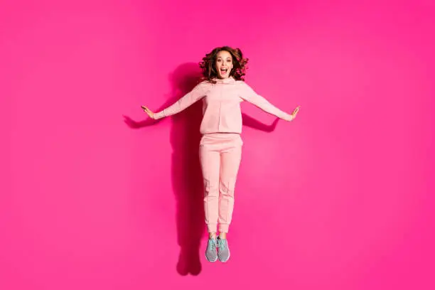 Full length body size photo jump high amazing she her lady hands arms flirty raised cute sweet wearing casual pink costume suit pullover outfit isolated vibrant rose background