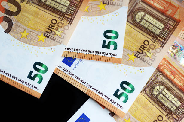 istock Fifty euro banknotes on a dark background close up 1129079738