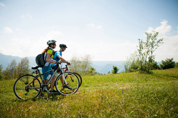 istock ACTIVE Young couple biking on a forest road in mountain on a spring day 1129081022