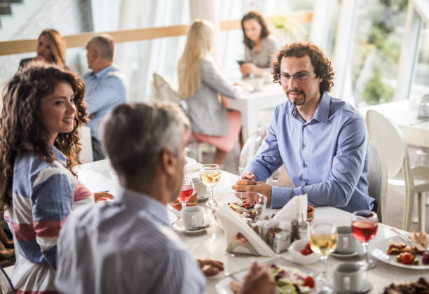 istock Team of business people having a conversation during lunch break in cafeteria. 1129081226