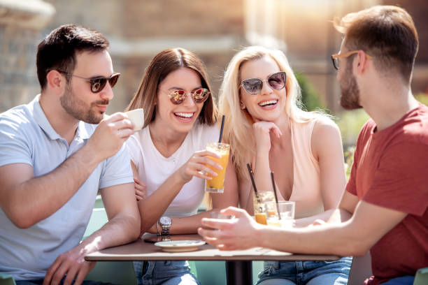 istock Group of four friends having fun in cafe 1129081242