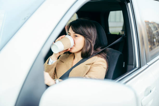 istock woman driving car. safety belt 1129081417